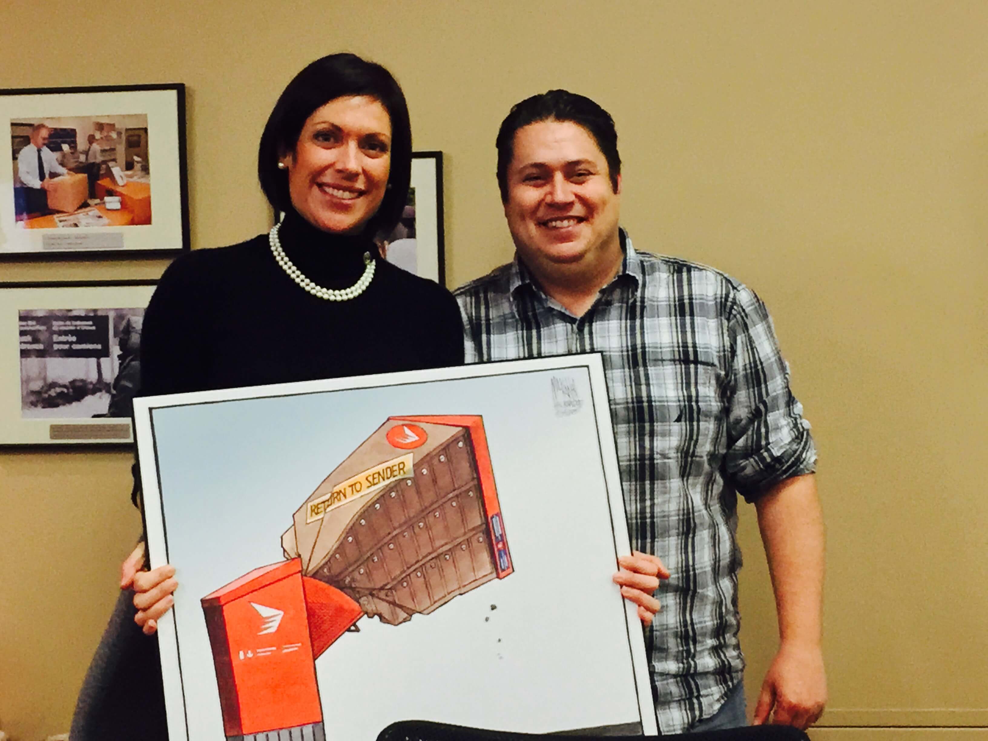 Presenting Karine Trudel with the ‘Return to Sender’ post-election CMB cartoon from the Chronicle-Herald