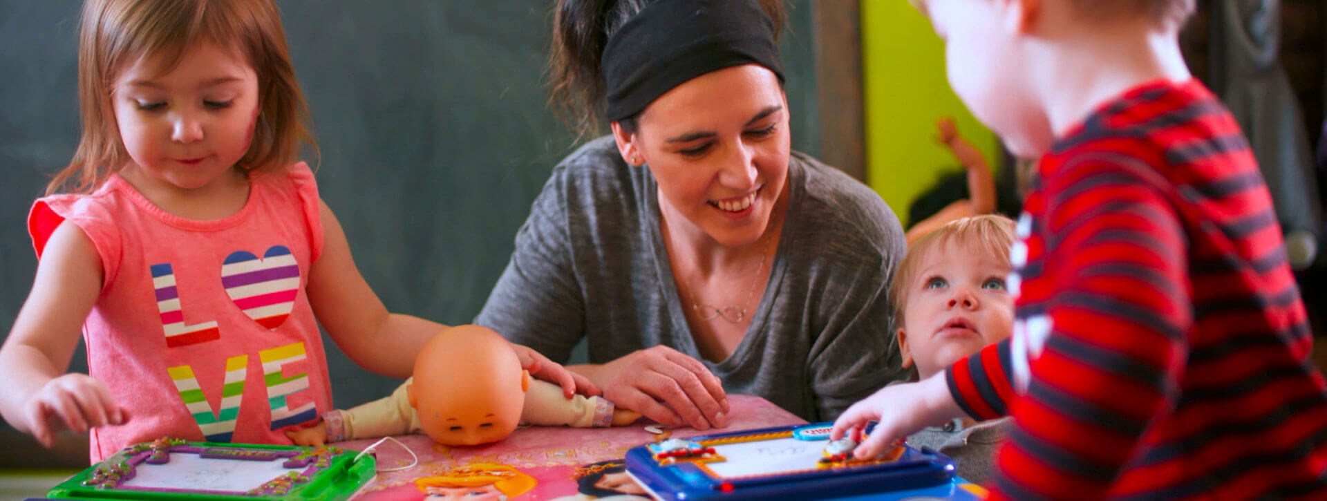 Two children smiling and hugging while standing on top of a hopscotch board at a day care facility. Two children smiling and hugging while standing on top of a hopscotch board at a day care facility.